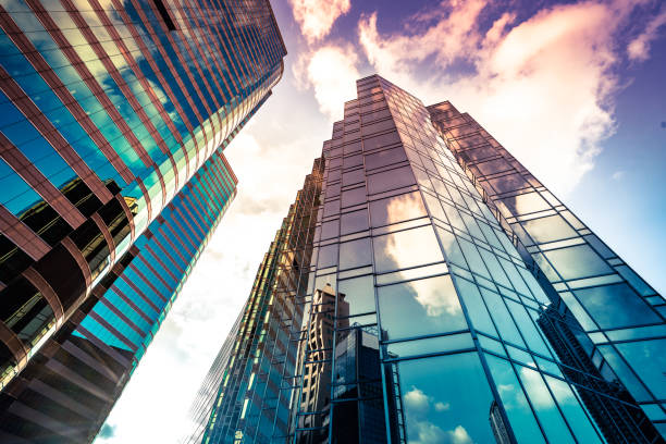 Looking up a reflections on glass covered corporate building